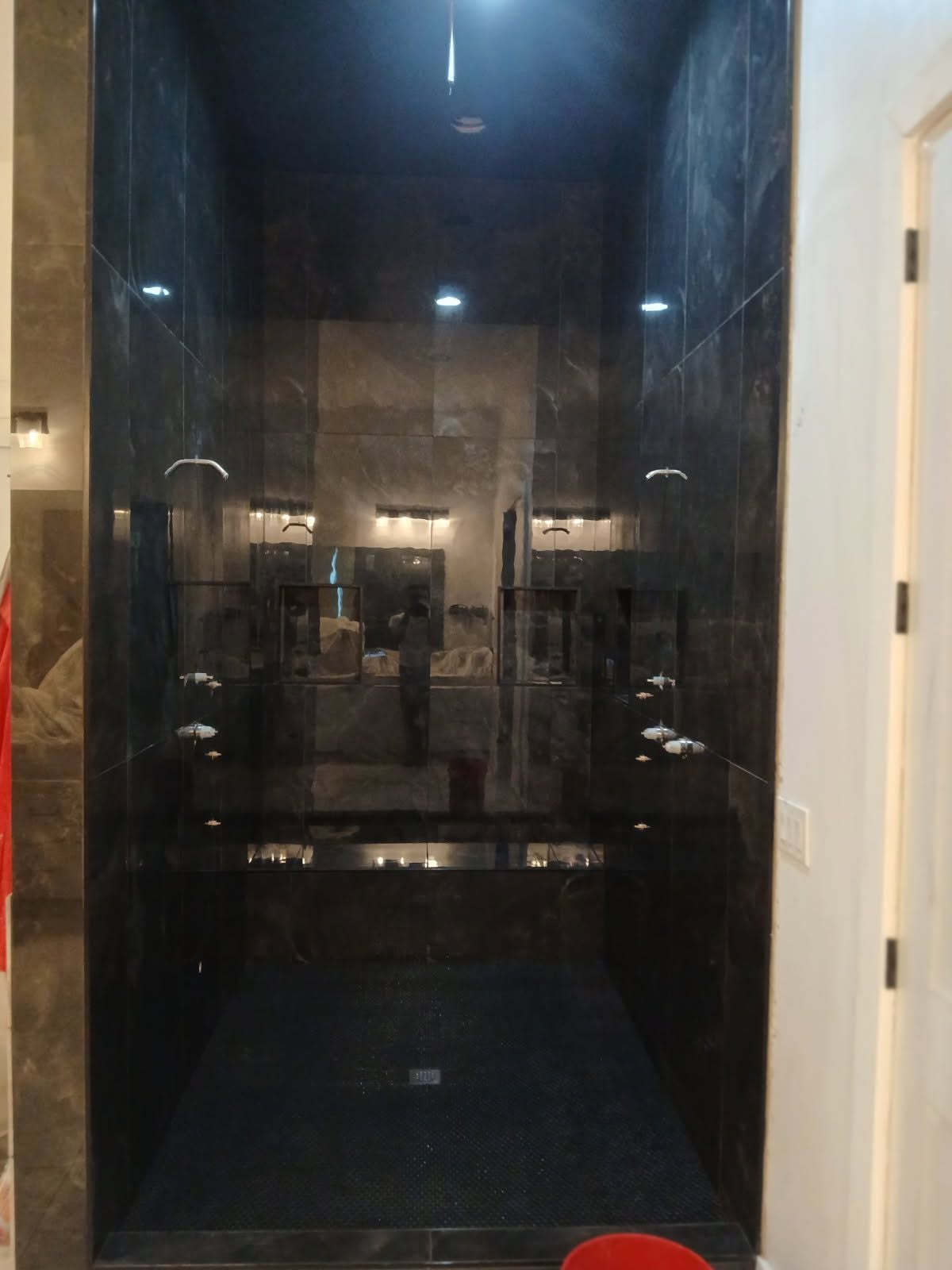 Polished black marble double shower with dual rain heads