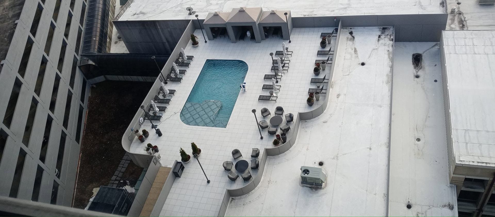 Rooftop pool deck with white tile surround