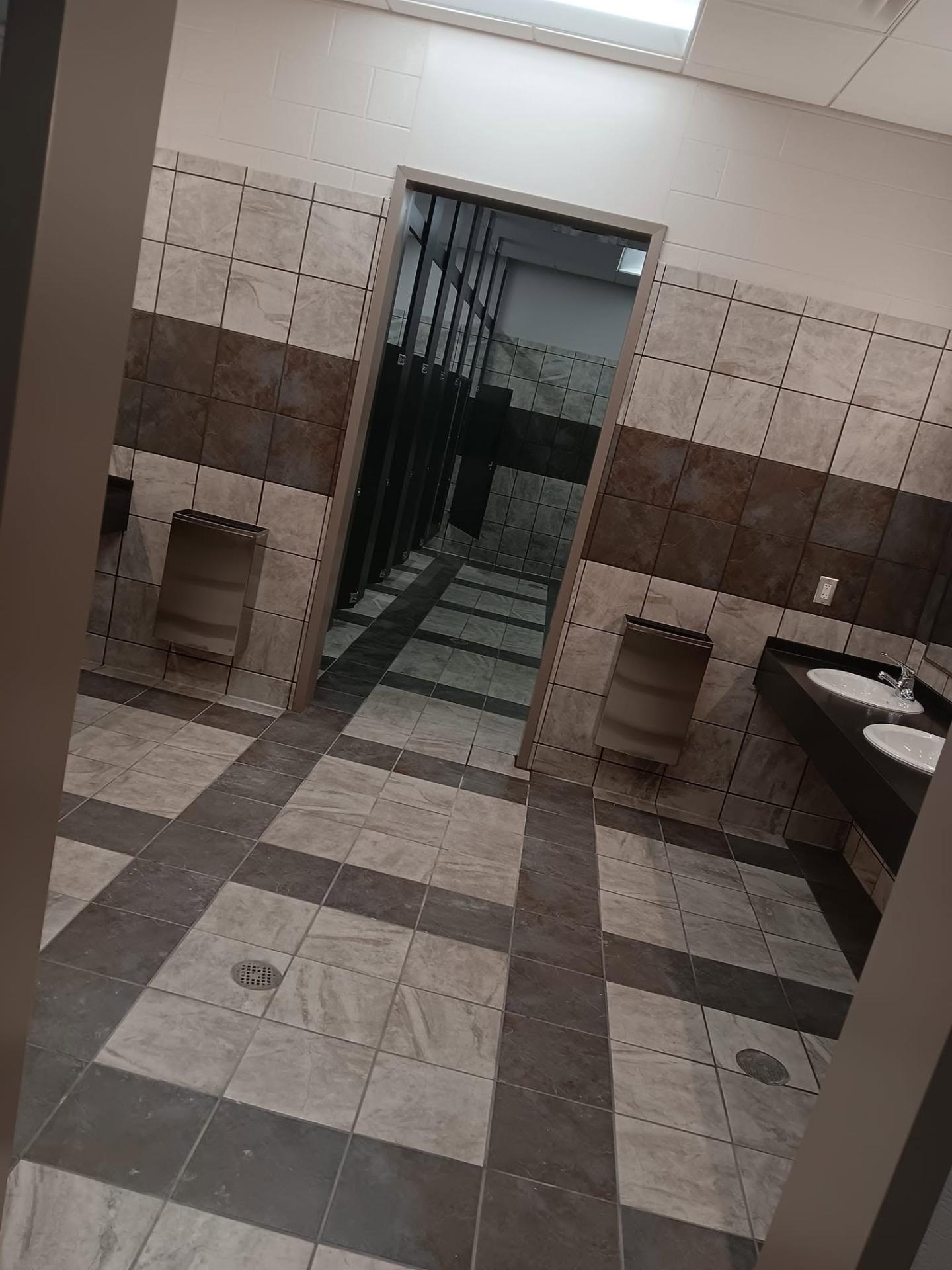 Commercial restroom floor with grey and brown grid tile