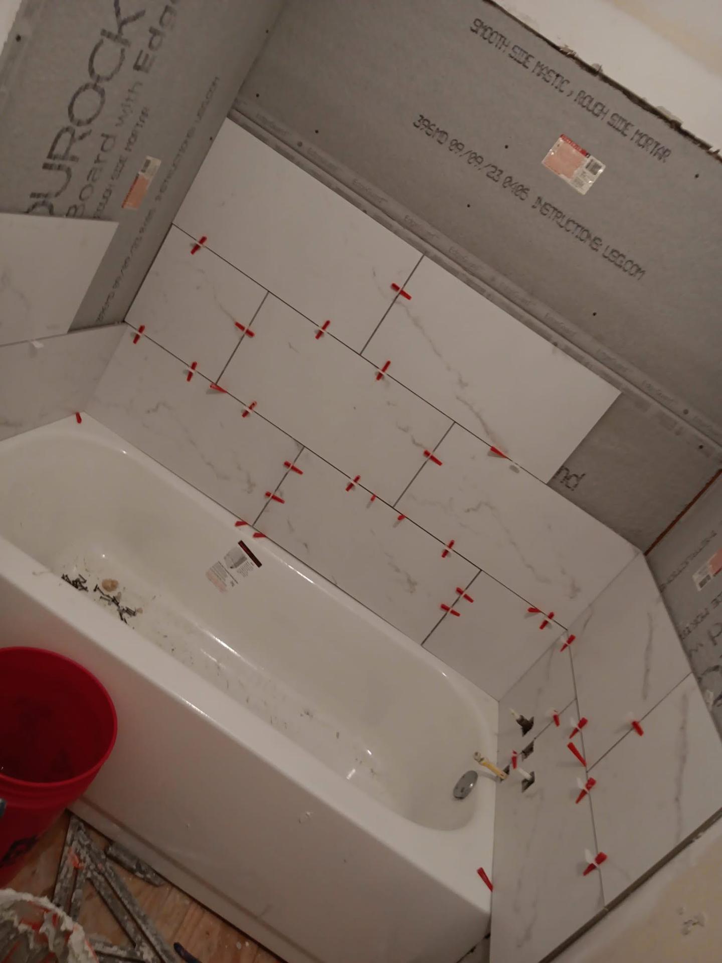 White marble tile installation around a bathtub