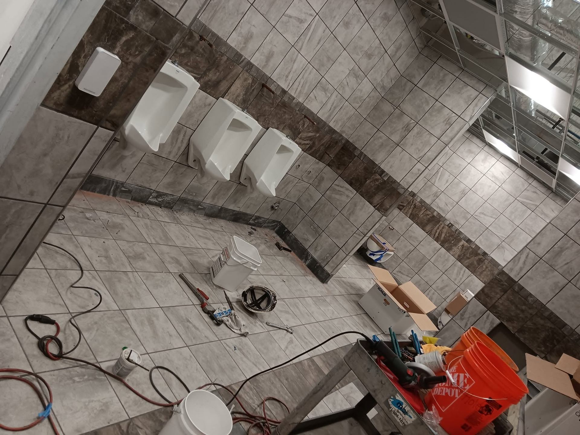 Commercial restroom under construction with tiled floors