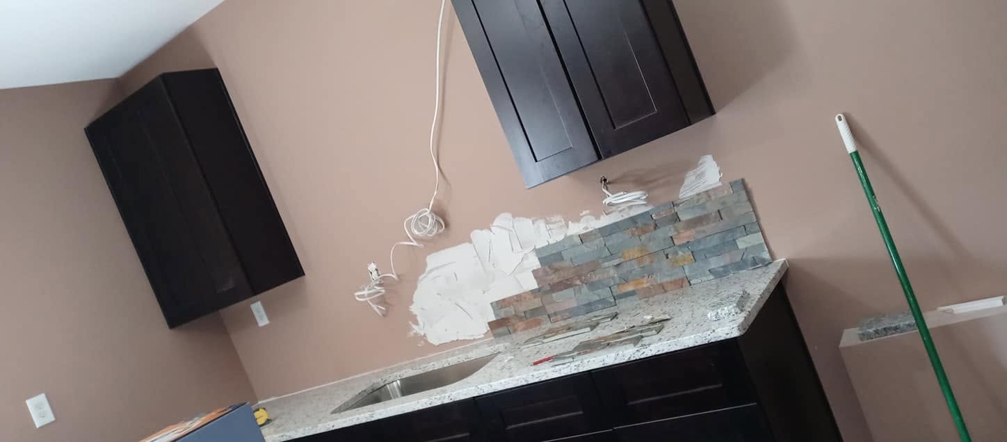 Stacked stone accent backsplash in progress